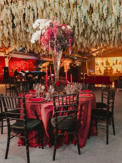 A beautifully set table at a red-and-velvet themed cocktail night, ready for guests to arrive.