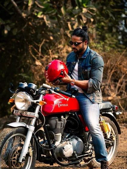 A classic "rider with his helmet" shot. The red of the bike and helmet provides a great pop of color.