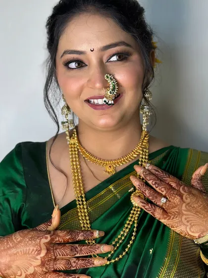 A joyful bride showing off her complete Vidhi look, including her intricate henna and perfectly matching nail art.