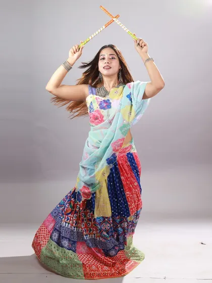 A dynamic, high-energy shot from a Garba-themed studio shoot. I used a fast shutter speed to freeze the motion of the model and her dandiya sticks, capturing the joyful spirit of the dance.