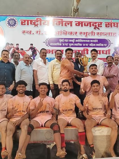 Our players seated on the victory stage, acknowledging the win at the Rashtriya Mill Mazdoor Sangh tournament.
