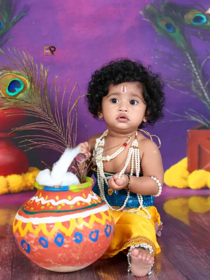 A close-up of the baby Krishna, looking curiously at the pot of "butter." The rich colors and textures of the setup create a visually stunning image.