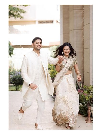 A joyful, candid shot of the newly engaged couple running and laughing. This image is full of movement and happiness, capturing the excitement of their new chapter.