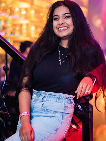 A guest smiling on the stairs.