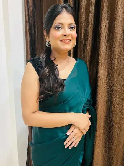 A smiling portrait of the client, looking confident and beautiful with her party makeup. The look is glamorous but not overpowering, enhancing her natural beauty.