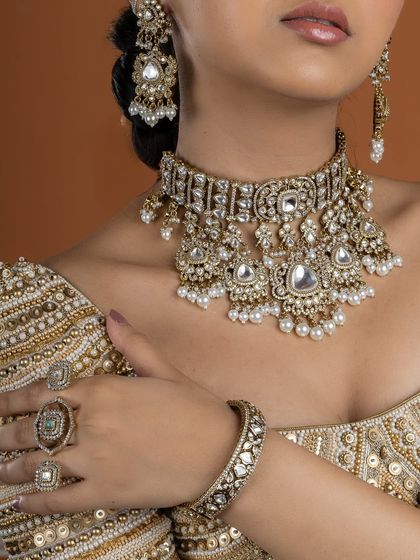 A detailed view of our royal choker set, showcasing the matching statement bangles and rings. This look is a perfect example of traditional craftsmanship meeting contemporary design.