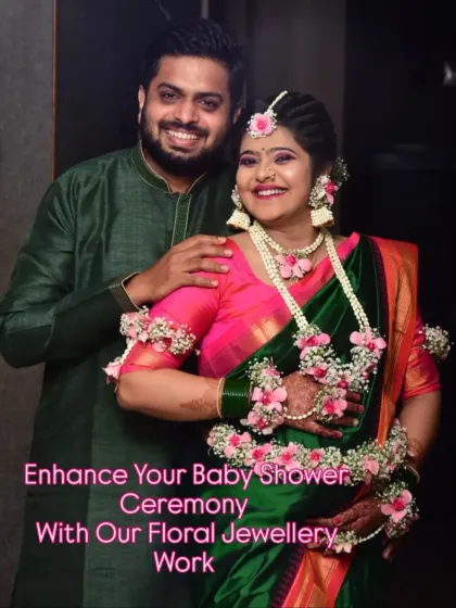A happy couple celebrating their baby shower. Her floral jewellery adds a special touch of tradition and beauty to the occasion.