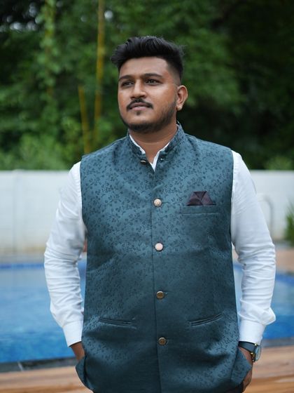 The dark green waistcoat has a subtle traditional pattern, making it a versatile piece for various occasions. Rent it to add a touch of class to your look.