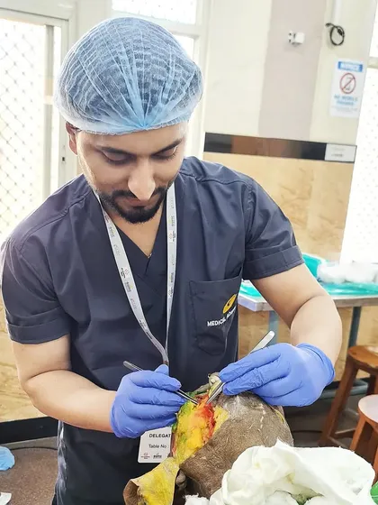 Here I am focused during a hands-on dermatosurgery workshop. My training in surgical dermatology allows me to perform precise procedures for conditions like moles, cysts, and keloids, always prioritizing patient safety and effective results.
