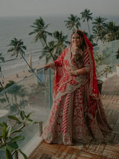A bride overlooking the sea from her balcony in Goa. We make sure to incorporate the stunning views of your destination into your bridal portraits for a true sense of place.