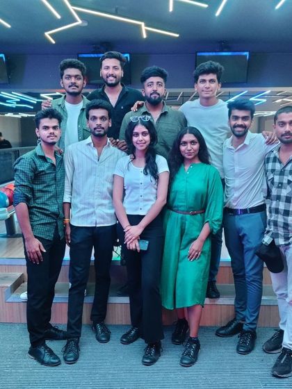 A group of friends posing together at the bowling alley.