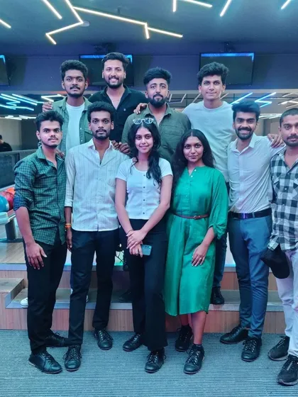 A group of friends posing together at the bowling alley.