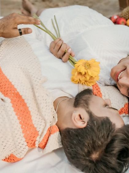 An overhead shot of the couple lying on a picnic blanket, sharing a moment of connection. This creative angle provides a unique perspective on their pre-wedding shoot.