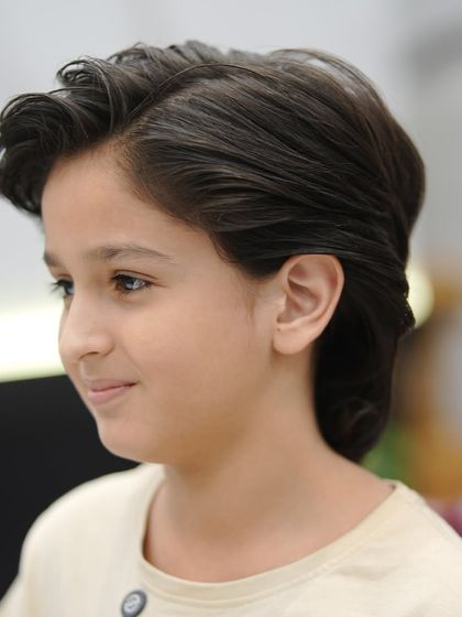 A classic haircut for a young boy. It's a timeless style that looks neat and handsome.