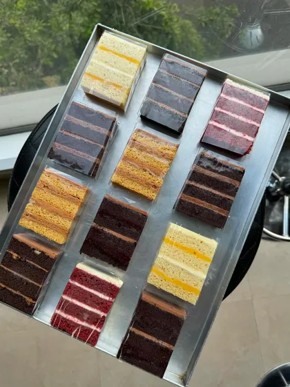 A tray of our individual cake slices, ready to be sold at the cafe. We have six flavours available to choose from.