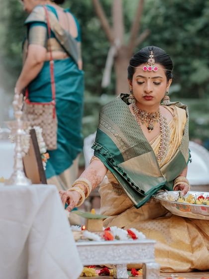 A candid from the puja, her focus and grace evident.