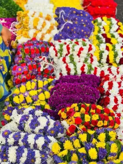 A variety of fresh flower arrangements being prepared for an event. We can create custom color combinations to match your event's theme.