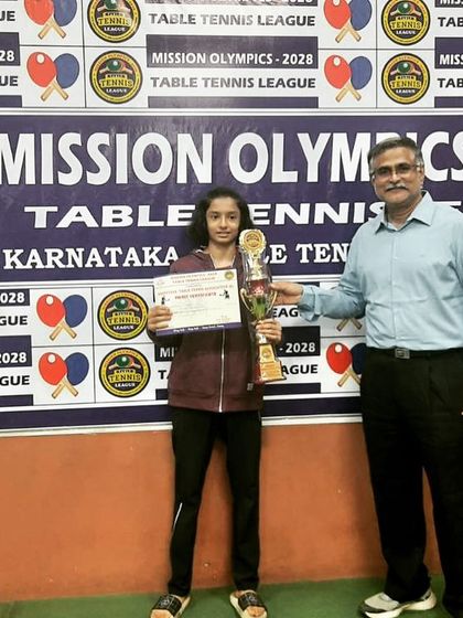 Preksha T receiving her gold medal at the Under-19 Mission Olympics event, where she competed against top-ranked players from both girls' and boys' categories.
