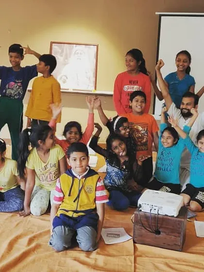 A fun group photo with the kids. The goal is to introduce them to yoga as a joyful process, a tool they can use for the rest of their lives.