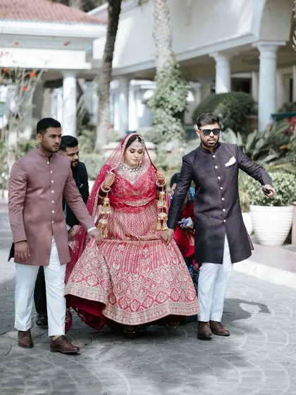 The bride's grand entrance, carried on a doli by her brothers. A powerful and traditional moment, captured with a modern, candid feel.