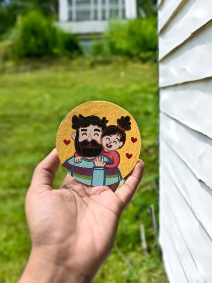 A simple yet sweet Father's Day coaster with an illustration of a dad and daughter hugging.