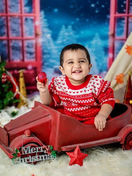 This little cutie is having a great time in our Christmas sleigh prop.