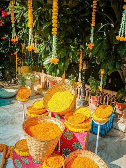 A traditional Haldi decor element, with baskets of fresh marigold petals ready for the ceremony.