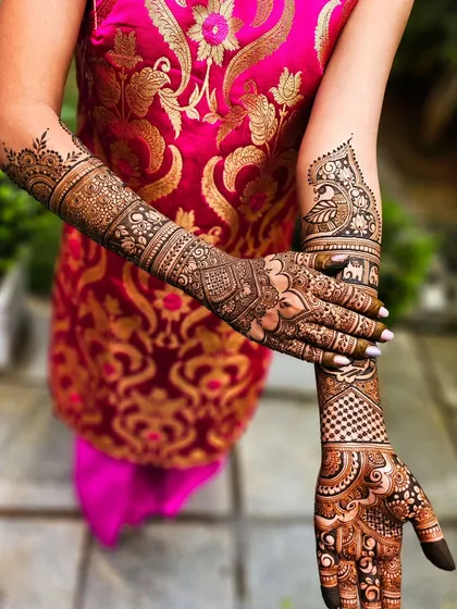 A creative pose showing the intricate details on both the inner and outer arms.