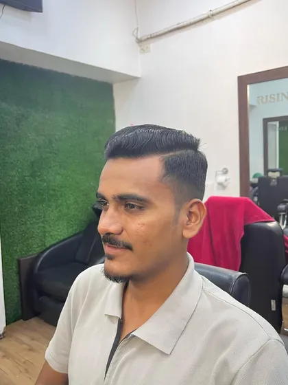 A clean low fade cut, perfect for a subtle yet stylish look. This haircut is versatile and easy to maintain.