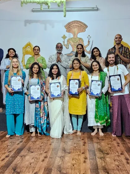 A group of smiling graduates from our Yin Yoga TTC, celebrating their certification and the deep learning journey they shared.
