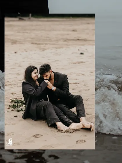 A tender moment on the sand, as the groom-to-be kisses his fiancée's hand during their beach pre-wedding shoot.