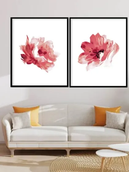 This set of two framed prints features delicate, abstract red flowers on a clean white background. The minimalist design is both modern and elegant, adding a splash of color to your walls.