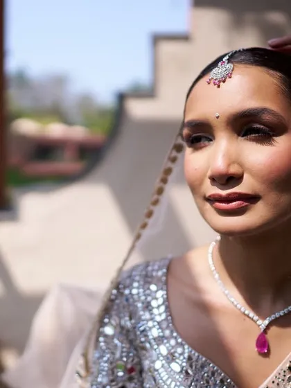 Destination weddings require makeup that can withstand any weather. For this beautiful bride in Goa, we created a humidity-proof look with a sleek bun and luminous, champagne-toned makeup that reflected the sun and sea, keeping her flawless from the first look to the last dance.