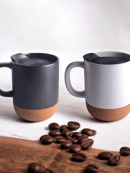 These modern coffee mugs feature a ceramic top and a natural cork base, preventing slips and protecting surfaces. They are a stylish and practical addition to any eco-conscious gift hamper.