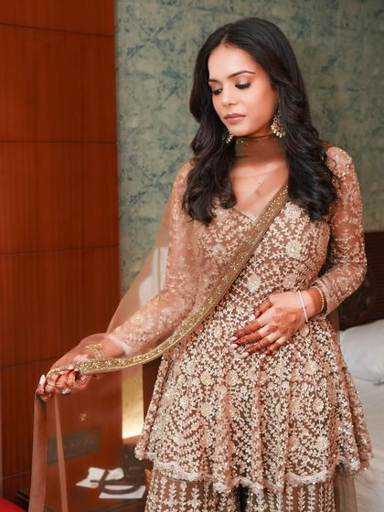 This bride is the picture of elegance in her embellished gown. The makeup is soft and subtle, with a focus on a flawless complexion and a gentle glow.