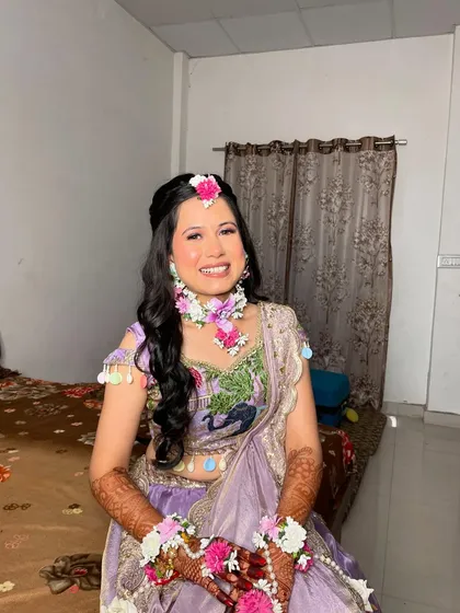 A big, happy smile from our Haldi bride. Her look is all about celebrating this joyous pre-wedding ritual.