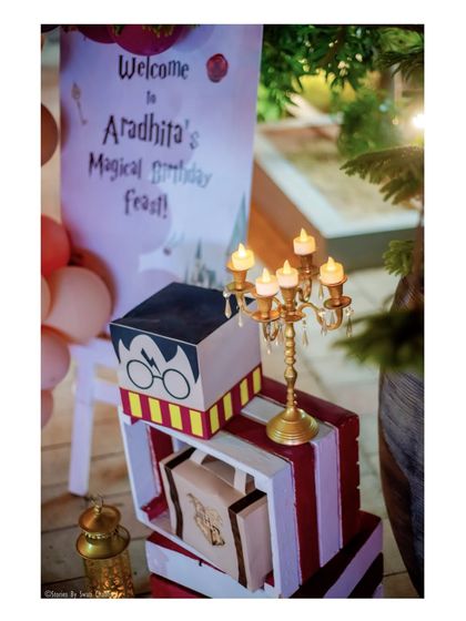 A 'Magical Birthday Feast' welcome sign, complete with a candelabra and a Harry Potter-themed gift box, setting an enchanting tone.