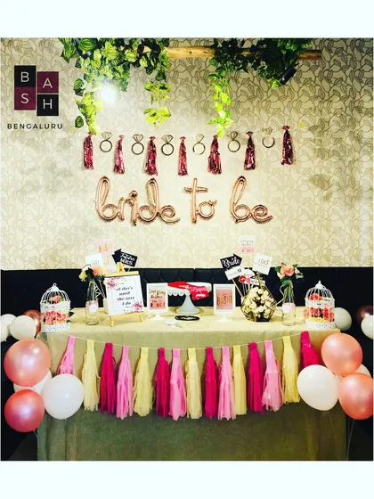 Another angle of a bridal shower setup, showing how the table decor, balloons, and wall hangings come together to create a cohesive and festive party zone.