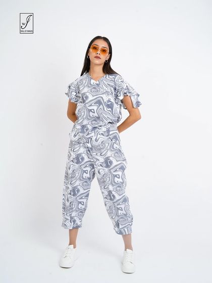 A full-length view of the marble-print outfit, perfect for a streetwear or youth fashion brand.