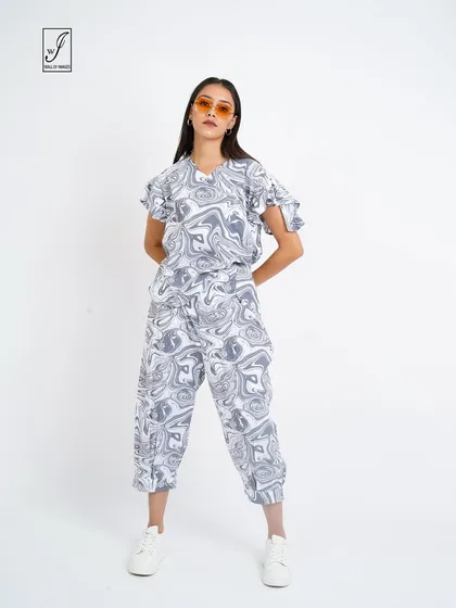 A full-length view of the marble-print outfit, perfect for a streetwear or youth fashion brand.