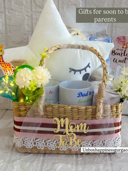 This hamper for soon-to-be parents includes a "Mom To Be" basket sash, "Dad to be loading" mug, and a cute giraffe accent.