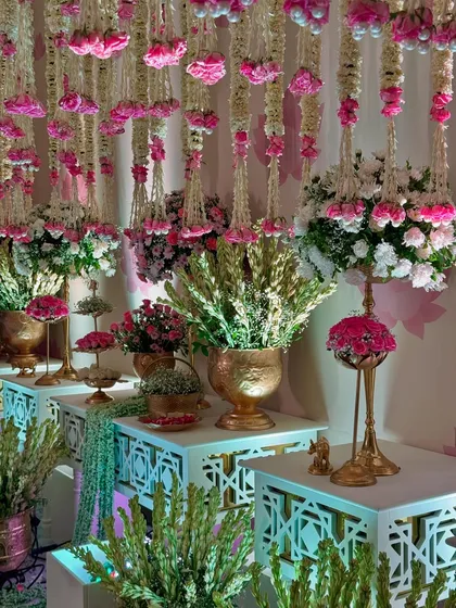 More views of the magical entrance, highlighting the density of the floral ceiling, the elegant decor pieces, and the soft, inviting lighting.