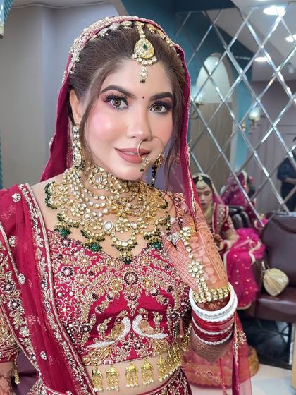 A beautiful three-quarter profile of the bride, showing how the makeup looks from different angles. The highlight on her cheekbones catches the light perfectly.