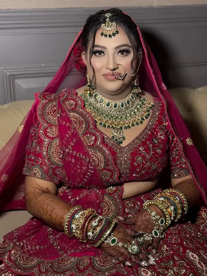 This bride is ready for her big day. The makeup is classic and elegant, with a focus on enhancing her features to create a timeless look.