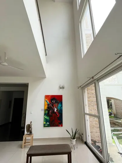 This angle showcases the interplay of natural light from the large windows and the interior architecture, creating a bright, airy atmosphere that changes throughout the day.
