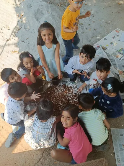We believe in learning through doing. Children get their hands dirty, mixing soil and crushed eggshells to enrich the earth for planting, a wonderful sensory activity that teaches them about nature's cycles.