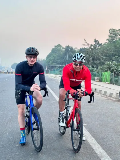Two riders posing on their bikes, ready to continue their journey.