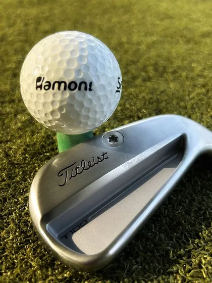 The perfect pairing. A new Titleist T100 iron sits beside our own Hamoni branded Srixon golf ball, ready for a pure strike on the range.