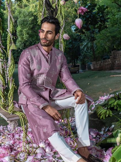A model relaxes on a swing, dressed in the elegant mauve kurta set. This image showcases how our ensembles blend tradition and contemporary style, allowing you to dress sharp and dance freely.
