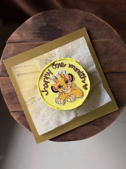 A cute cake for a one-month celebration featuring baby Simba from "The Lion King." It's a perfect little cake for the little king of your heart.